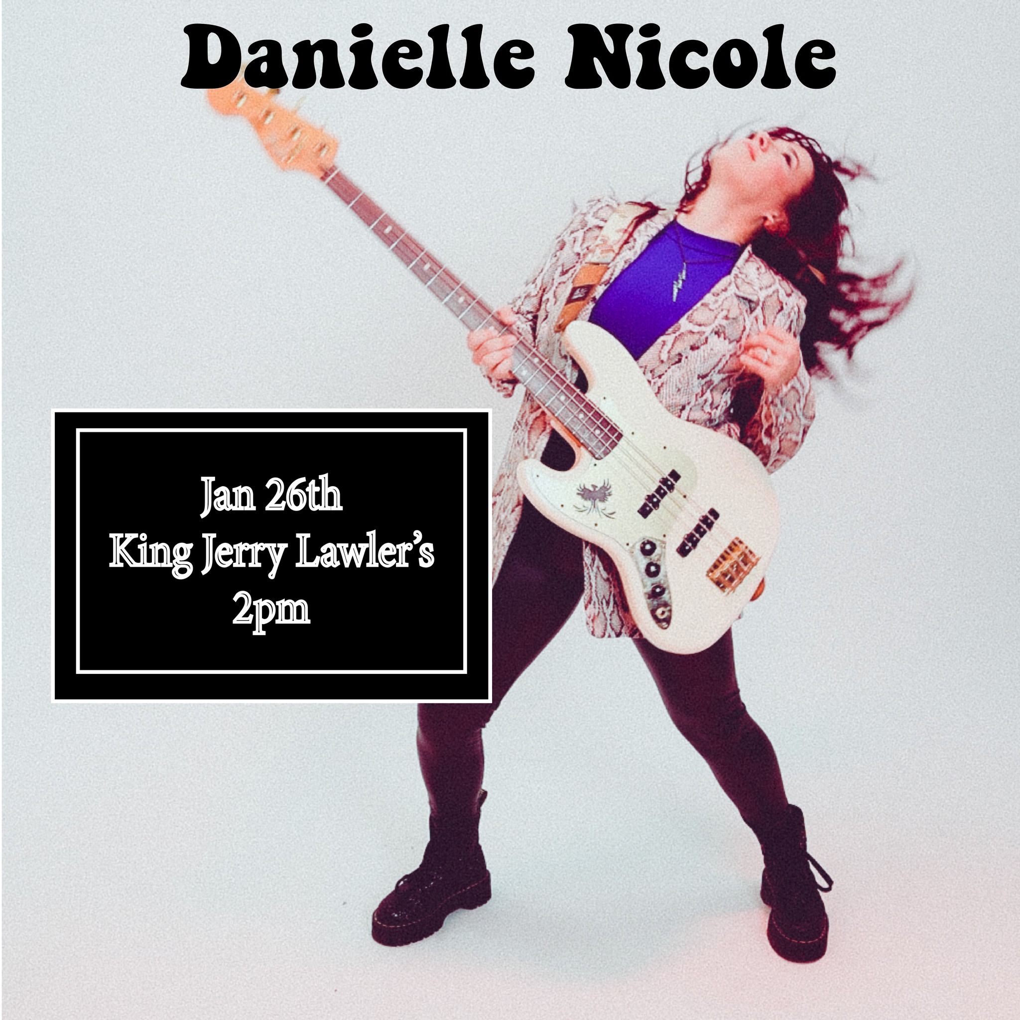 Danielle Nicole playing her bass with a sign for the workshop time and location